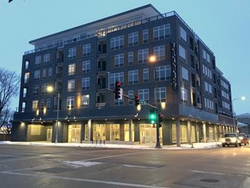 Rochester apartment for rent - an apartment building on the corner of a city street at night