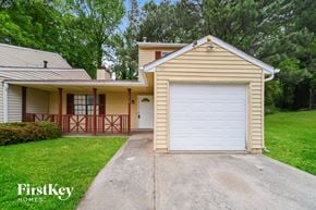 Atlanta house for rent - A house with a garage door is for sale by FirstKey Homes.
