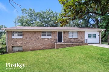 Conyers house for rent - front view of a brick house with a lawn and a black door