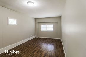 Conyers house for rent - the spacious living room with hardwood flooring and two windows
