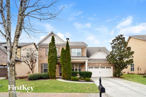 Buford house for rent - a house with a driveway and two trees in front of it