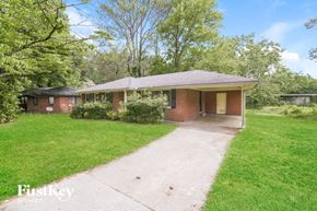 Forest Park house for rent - a brick house with a yard and a driveway