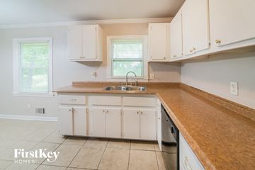Forest Park house for rent - a kitchen with white cabinets and a counter top