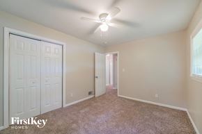 Forest Park house for rent - a bedroom with a ceiling fan and a closet