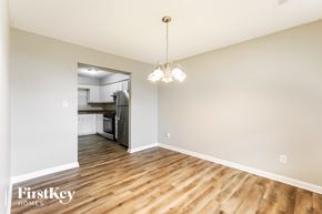 Riverdale house for rent - A well-lit, spacious room with wooden flooring and a chandelier hanging from the ceiling.
