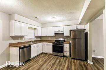 Riverdale house for rent - A kitchen with wooden floors and stainless steel appliances.