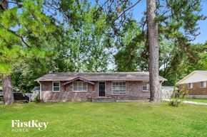 Jonesboro house for rent - a small brick house with a lawn and trees