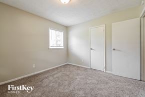 Jonesboro house for rent - a bedroom with carpet and a door to a closet