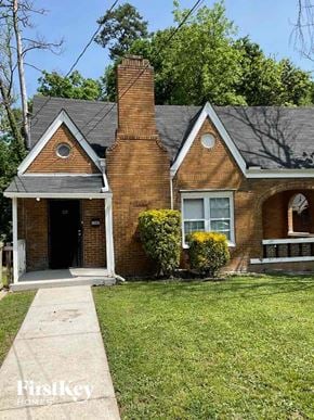 Atlanta house for rent - A brick house with a black door and a small porch.