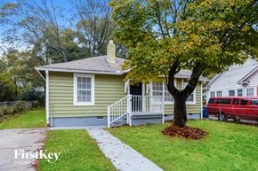 Atlanta house for rent - a small green house with a tree in front of it