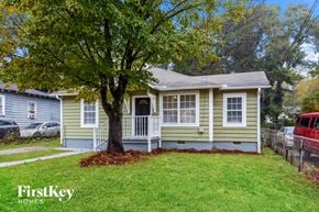 Atlanta house for rent - a small yellow house with a tree in the front