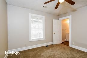 Atlanta house for rent - a bedroom with a ceiling fan and a white door