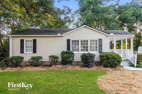 Decatur house for rent - A house with a white porch and a sign that says FirstKey Homes.