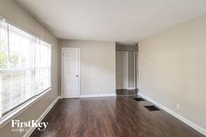 Decatur house for rent - A room with wooden floors and a white door.