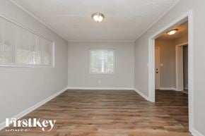 Atlanta house for rent - the spacious dining room with hardwood floors and a large window