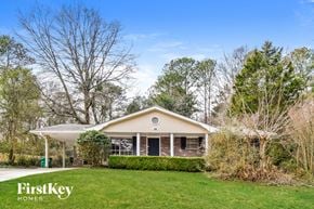 Decatur house for rent - a small white house with a lawn and trees