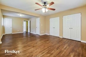 Decatur house for rent - a living room with a ceiling fan and a wood floor
