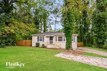 Decatur house for rent - a small white house with a yard and trees
