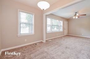 Decatur house for rent - an empty room with a ceiling fan and two windows