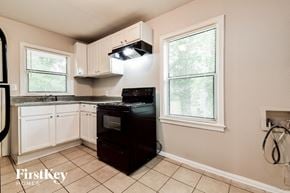 Decatur house for rent - a kitchen with black appliances and white cabinets