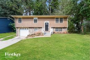 Lithonia house for rent - a small brown house with a lawn in front of it