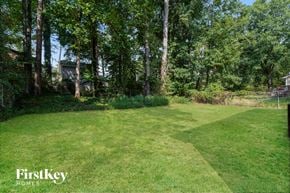 Lithonia house for rent - a yard with trees and a house in the background