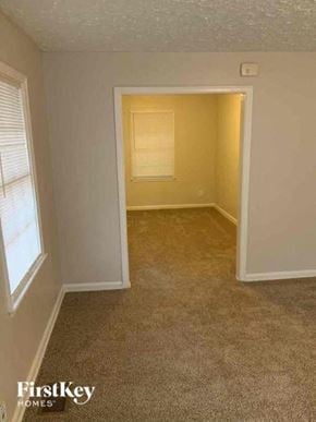 East Point house for rent - an empty room with a door and a window