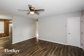 Gastonia house for rent - a living room with white walls and a ceiling fan