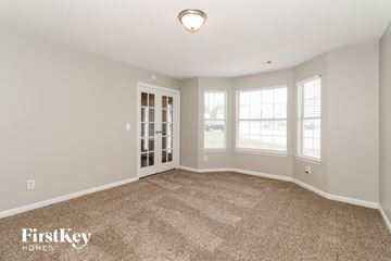 Decatur house for rent - a spacious living room with carpet and a door to the dining room