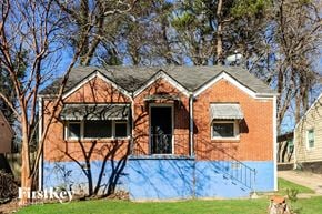 Decatur house for rent - A red brick house with a blue painted wall.