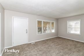 Decatur house for rent - A room with a carpeted floor, a white door, and a window with blinds.