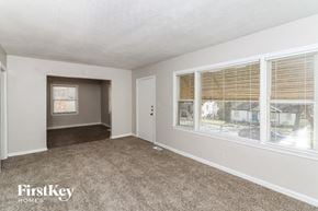 Decatur house for rent - A room with a carpeted floor and a window with blinds.