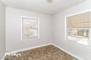 Decatur house for rent - A room with a window covered by blinds and a picture on the wall.