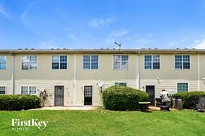 Hampton house for rent - A building with the words "FirstKey Homes" on a grassy area in front.