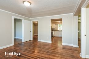 Atlanta house for rent - the living room and dining room of an empty house with wood floors