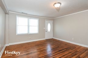 Atlanta house for rent - the living room of an empty house with a wooden floor
