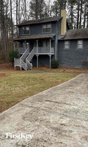 Marietta house for rent - A house with a grey porch and a concrete walkway in front.