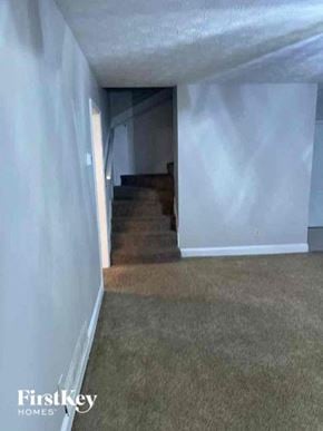 Marietta house for rent - A room with a staircase leading to another room.