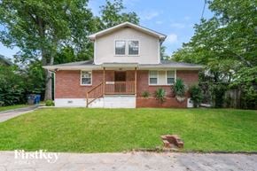 East Point house for rent - a brick house with a porch and a lawn