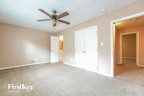 East Point house for rent - a bedroom with a ceiling fan and a door to a closet