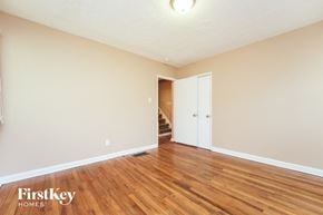 East Point house for rent - a living room with wood flooring and a door to a staircase