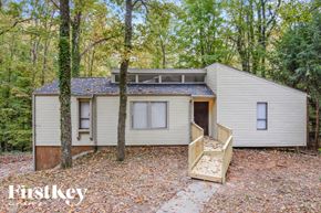 Marietta house for rent - a small white house with a porch and trees