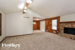Marietta house for rent - the living room has a stone fireplace and carpeted flooring