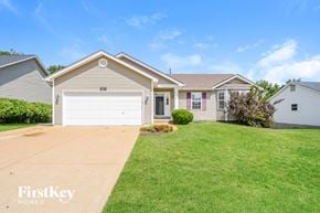 Imperial house for rent - a beige house with a white garage door and a lawn
