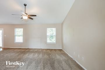 Imperial house for rent - a living room with a ceiling fan and a carpet