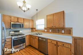 Imperial house for rent - a kitchen with wooden cabinets and stainless steel appliances and a white counter top
