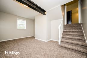 Ellenwood house for rent - A room with a staircase leading to another room.