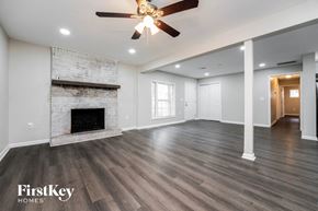 Decatur house for rent - a living room with a fireplace and a ceiling fan