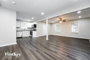 Decatur house for rent - a living room with a kitchen and a ceiling fan