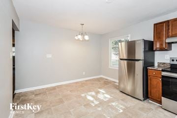 Atlanta house for rent - a kitchen with a stainless steel refrigerator and a stove